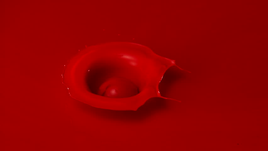 Dropping ball in paint making splash shooting with high speed camera.