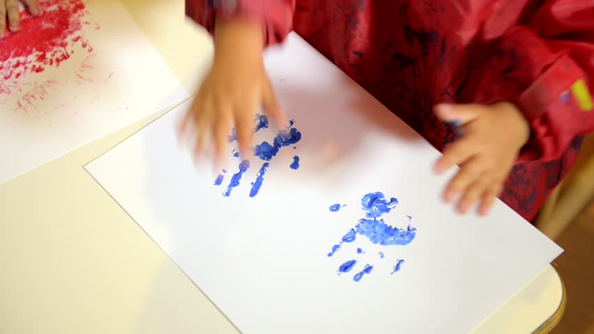 Happy children having fun and painting with hands in kindergarten. Sequence