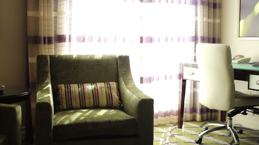 Opening the curtain in an upscale hotel room.