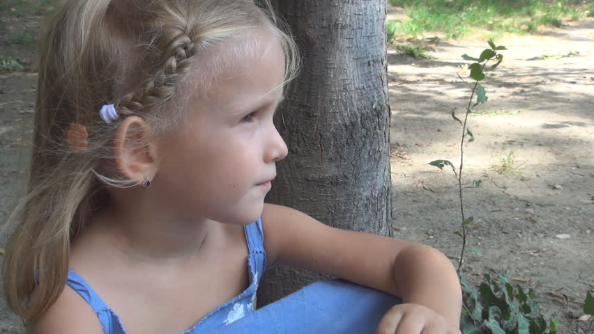 Sad Child at the Edge of a Lake, Melancholy Child Sitting at the Edge of the Lake, Bored Little Girl