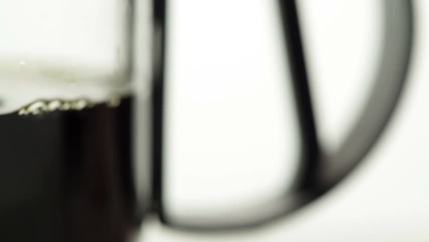 Coffeemaker, slow panning and zooming from the coffee decanters handle to the scale.