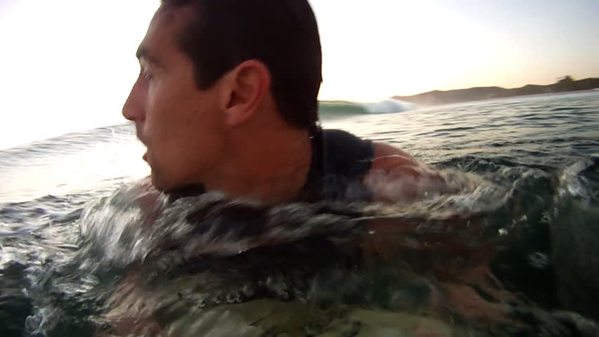 A Man Surfing and Breaking Through the Angry Waves