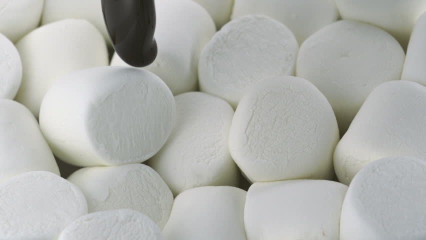 Chocolate sauce on marshmallow shooting with high speed camera.