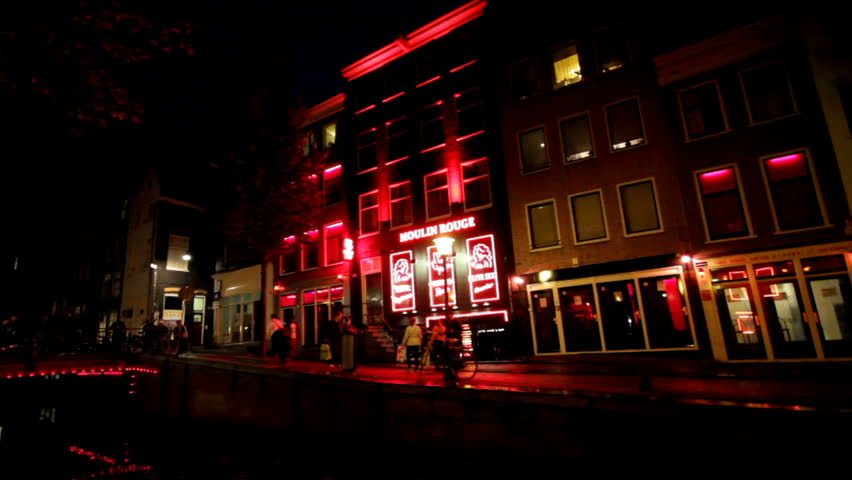 AMSTERDAM - OCTOBER 21: The Red-light district in Amsterdam, The Netherlands on October 21, 2012. The district has acquired a touristic interest beyond sex tourism, thus can be perceived as a place of artistic, historic and cultural interest.