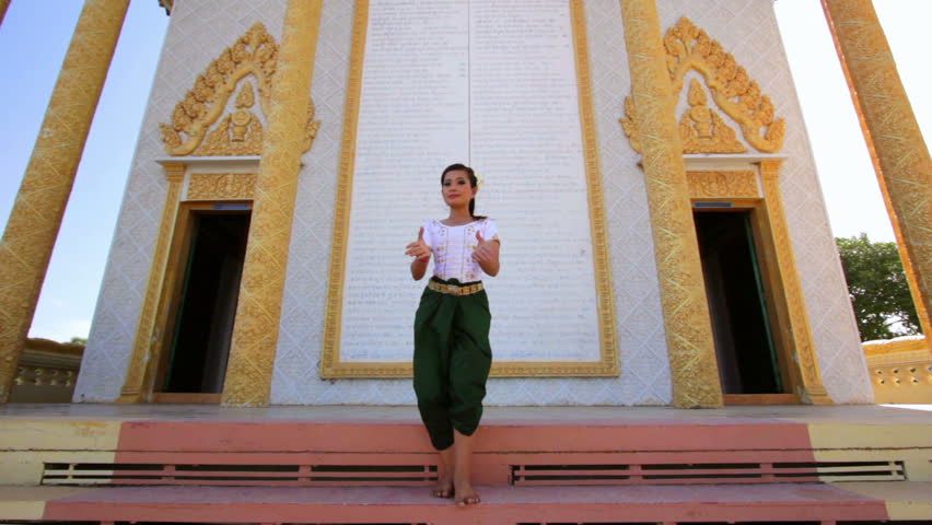 Very pretty Asian Girl performs Cambodian folk dance in temple