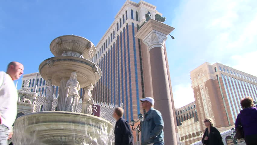LAS VEGAS, NEVADA - CIRCA 2012 - Las Vegas Boulevard Strip and the Venetian Hotel and Casino with people walking by on sunny day.