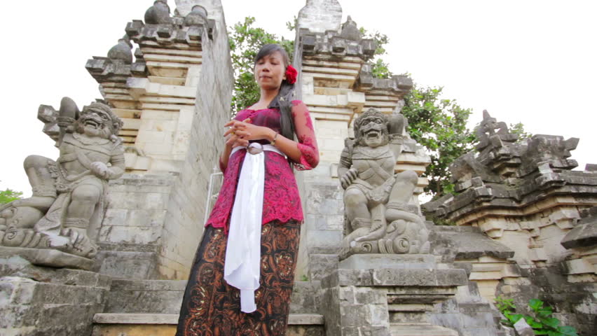 Balinese girl saluting with both hand in uluwatu temple, Bali