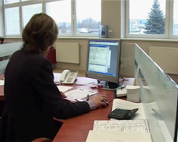 10 Dec, 2008. Ustilsk. Moldova. A member of the bank verifies the documents sitting at the table