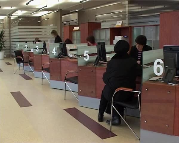 10 Dec, 2008. Ustilsk. Moldova. A member of the bank verifies the documents sitting at the table