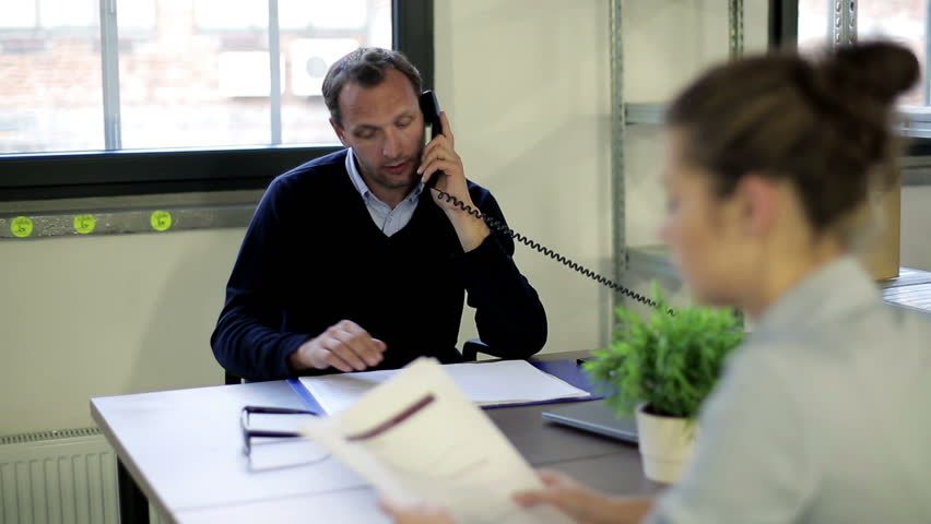 Young businessman talking on telephone in the office
