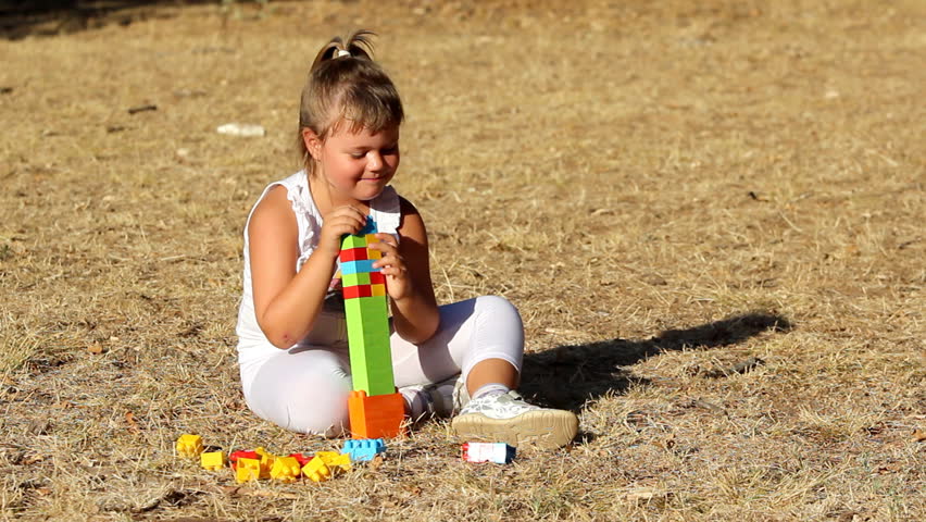 Child building

Description: Little girl building a house with plastic bricks      
