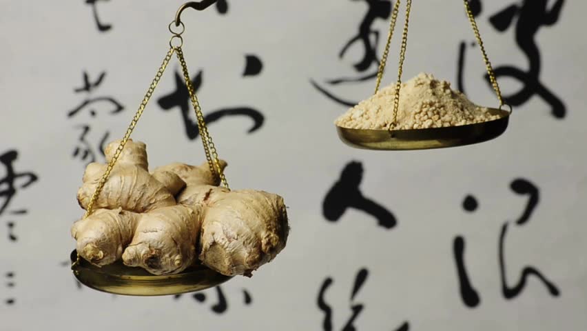 ginger, root and instant tea powder on a balance