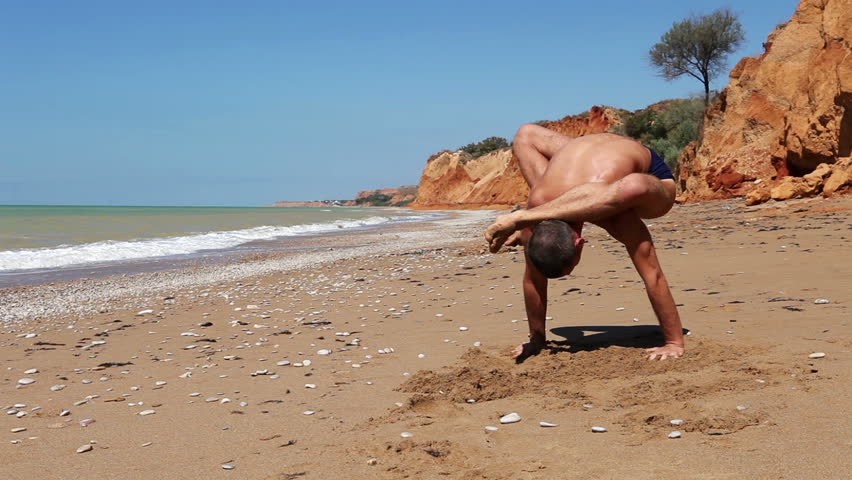 Yoga Power Push-Up Exercise on the wild Beach