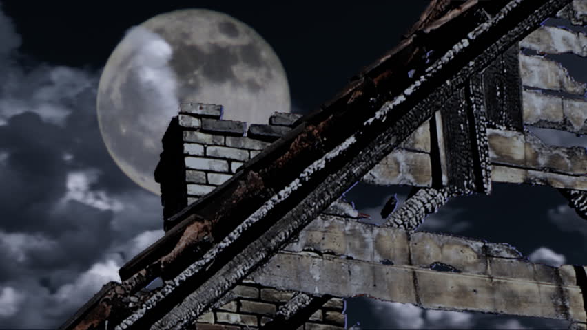 Spooky full moon shines through running clouds over dark haunted burnt down ghost house in mist HD 1080p