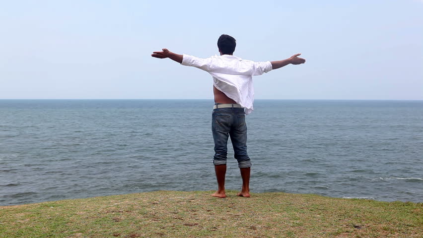 Carefree man enjoying at the beach, freedom concept