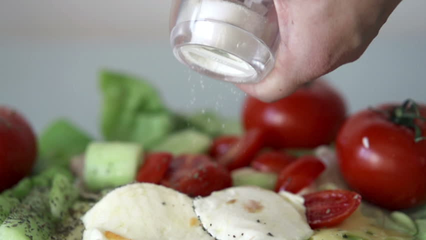 Hand sprinkle salt on mozzarella cheese, slow motion shot at 480fps
