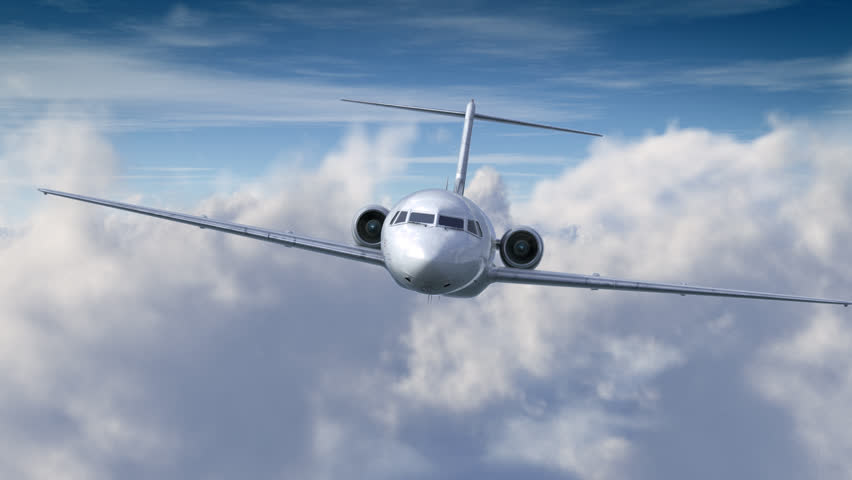 Front view of an Airplane above the clouds heading towards the camera
