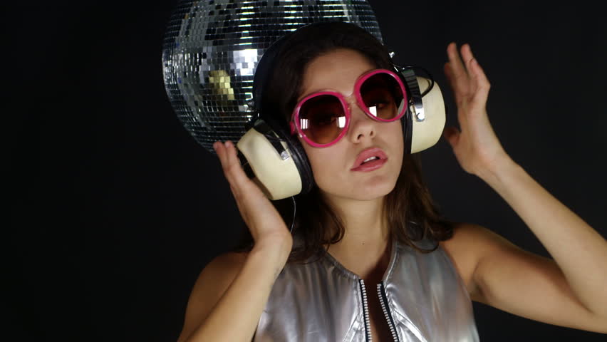 sensual studio shoot of a beautiful woman dancing in a silver outer space style costume