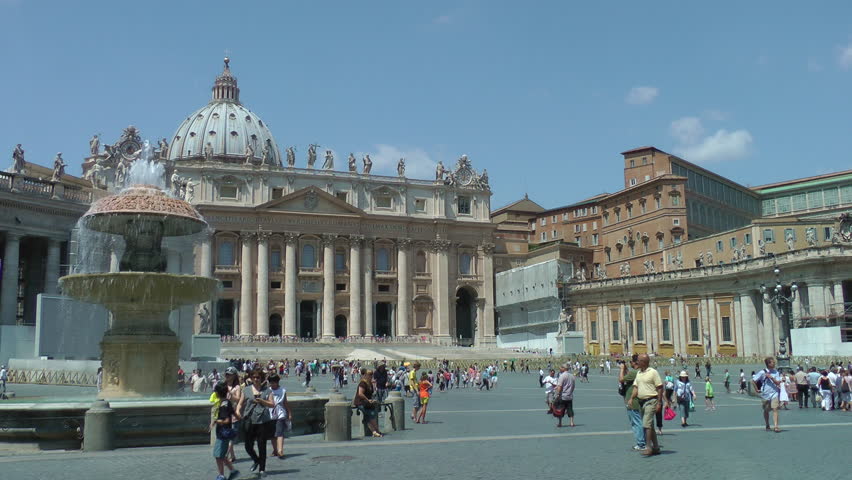 ROME, ITALY - CIRCA AUG 2012:  Enduring the summer heat, tourists stroll through St. Peter's Square, dome of Basilica and Bernini fountain in background.
