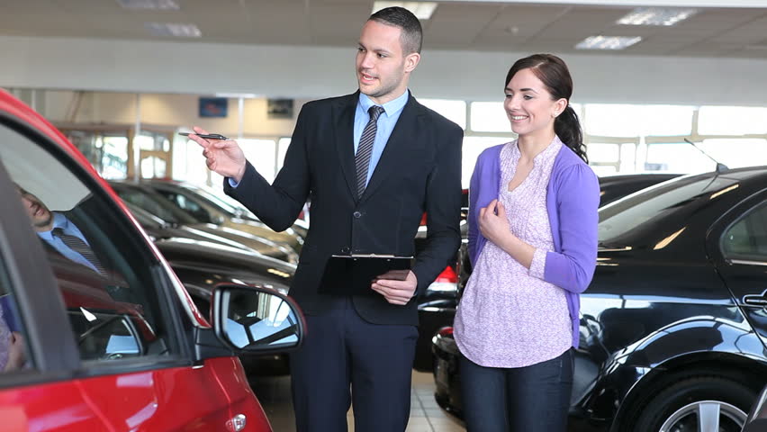 Businessman showing a car in a dealership