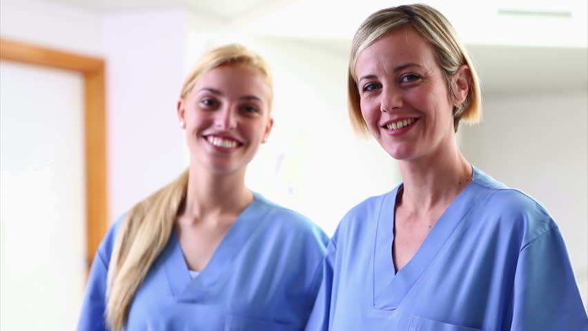 Nurses looking at camera while smiling in hospital