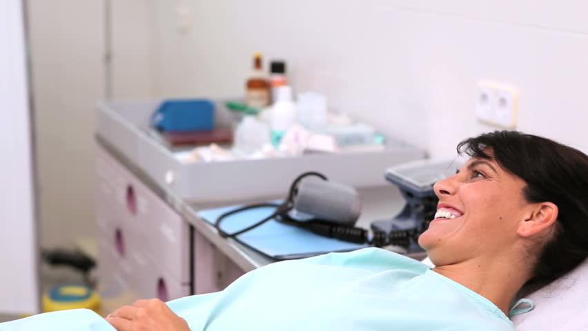 Video of a doctor checking pulse of a patient in hospital ward