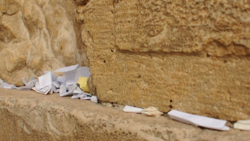 Hand asking for desire at the Western Wall. Jerusalem. Inserting paper.
