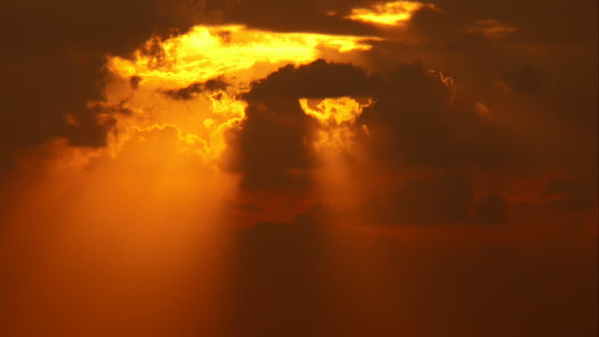 sunset time-lapse - sun / sunbeams passing through clouds.