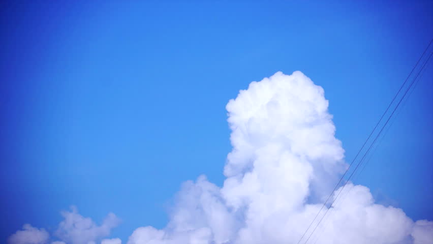 Time-lapse of clouds exploding upwards at the right Rule of Thirds.
