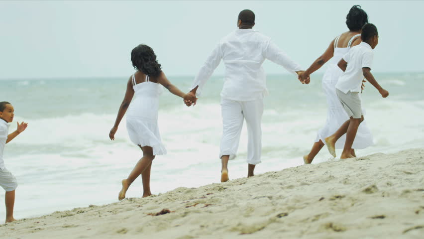 Summer time of diverse lucky family playing and relaxing on beach