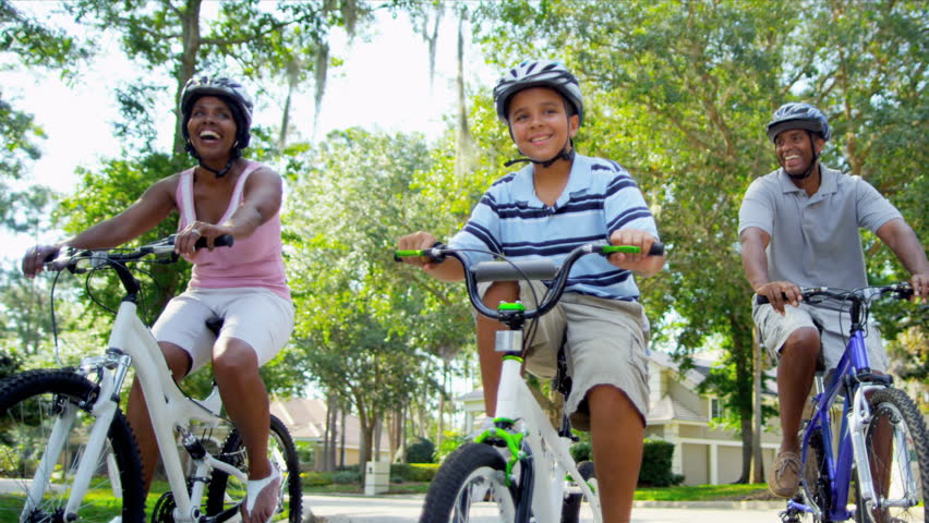 Healthy Fit Ethnic Family Cycling Suburban Roads