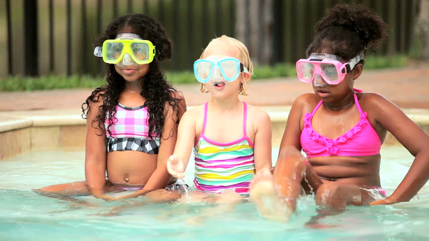 Diverse pre schoolgirls have fun in swimming pool