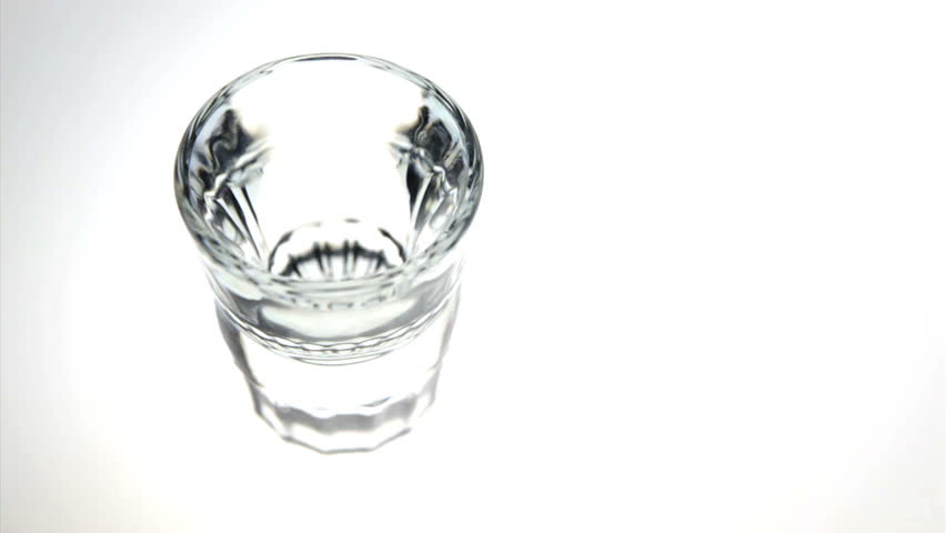 Liquor poured into a shot glass and drunk