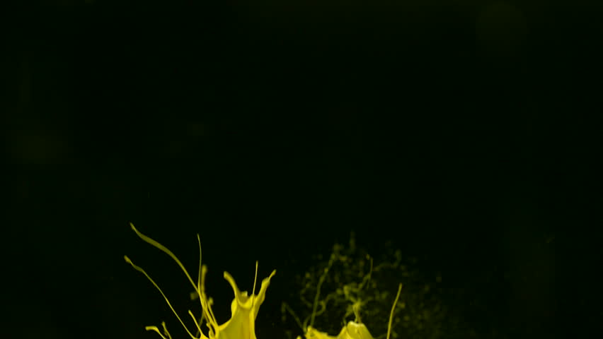 Yellow paint splash in the air shooting with high speed camera.