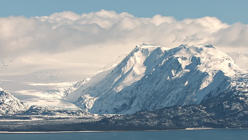 Heavy cumulus moving over the Kenai Mountains near Homer, Alaska, the Grewingk Glacier's terminal moraine in view.