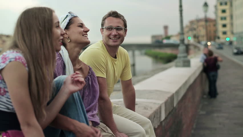 Young friends talking in the city, steadicam shot