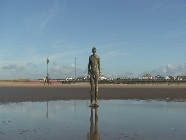  2 clips of Antony Gormley's Another Place statue's on Crosby Beach Liverpool UK