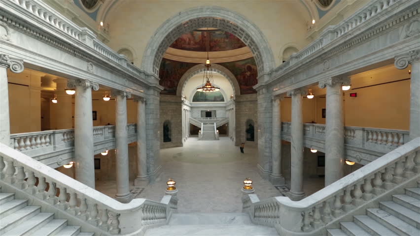 Utah State Capital rotunda couple visit. Utah State capital building high on a hill overlooking the city of Salt Lake City. Elegant architectural interior design made from marble and copper dome. 