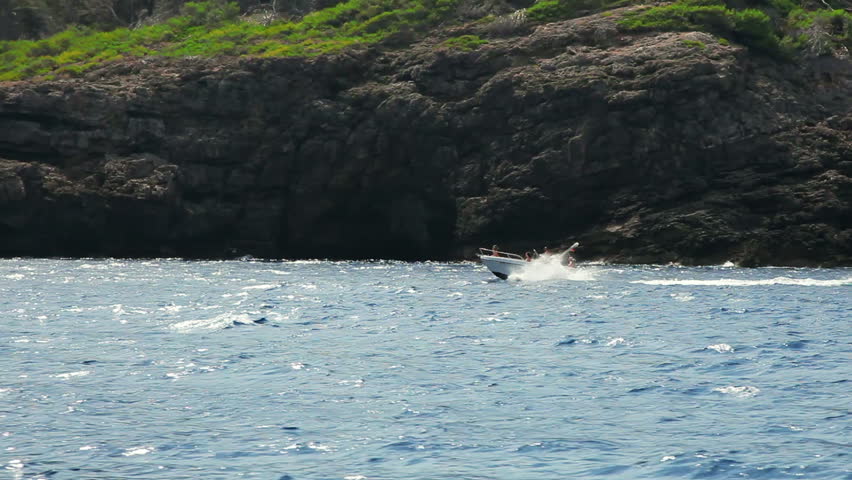 Fast motorboat jumps on waves of Mediterranean Sea, Mallorca Island, Spain
