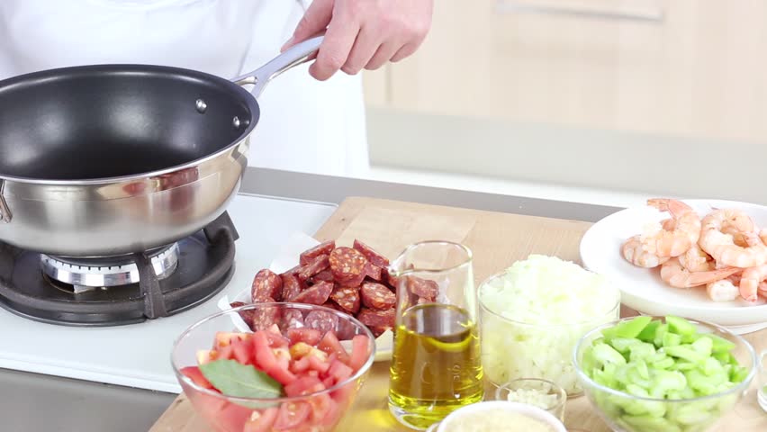 Sliced paprika sausage being fried in a pan