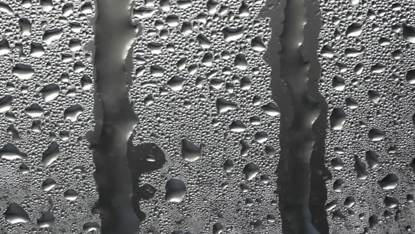Abstract background texture with flowing down water drops on glass