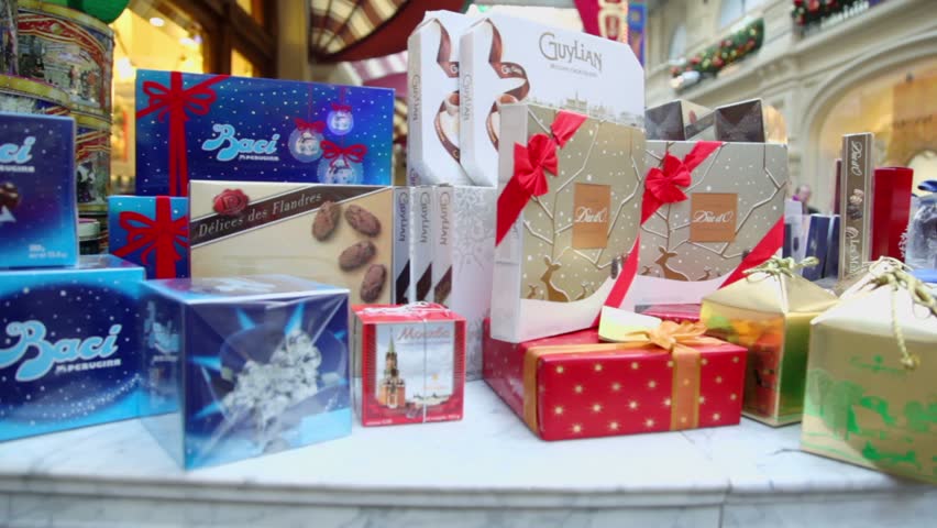 MOSCOW - JAN 20: Lot of present boxes with candies stand on showcase in GUM on Jan 20, 2011 in Moscow, Russia. GUM building hosting more than thousand stores.