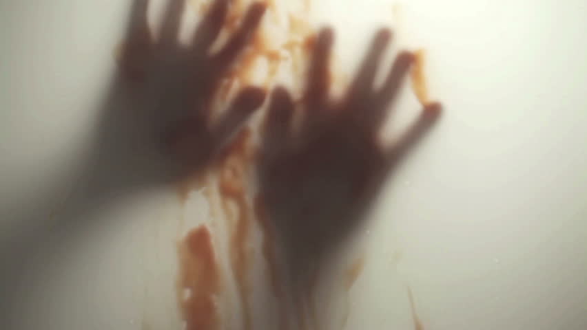 Blood-smeared hand - probably of a crime victim - behind frosted glass