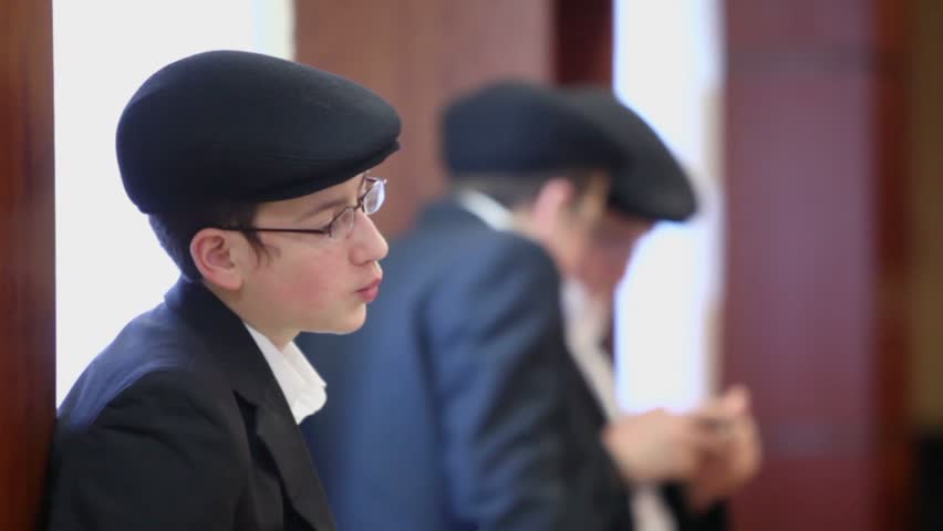MOSCOW - JAN 27: Jewish boys stand near wall in synagogue Beis Menachem at International Holocaust Remembrance Day, on Jan 27, 2012, Moscow, Russia.