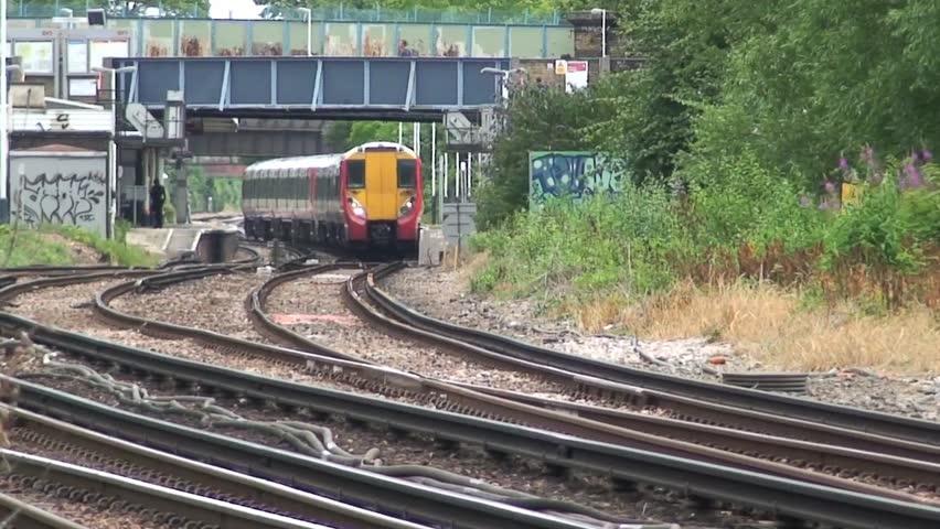 LONDON, UNITED KINGDOM - CIRCA 2011: Fast moving British Rail passenger train on tracks.