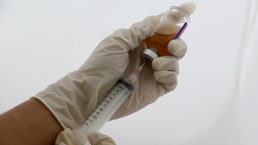 Vaccination process. Syringe and flack. 