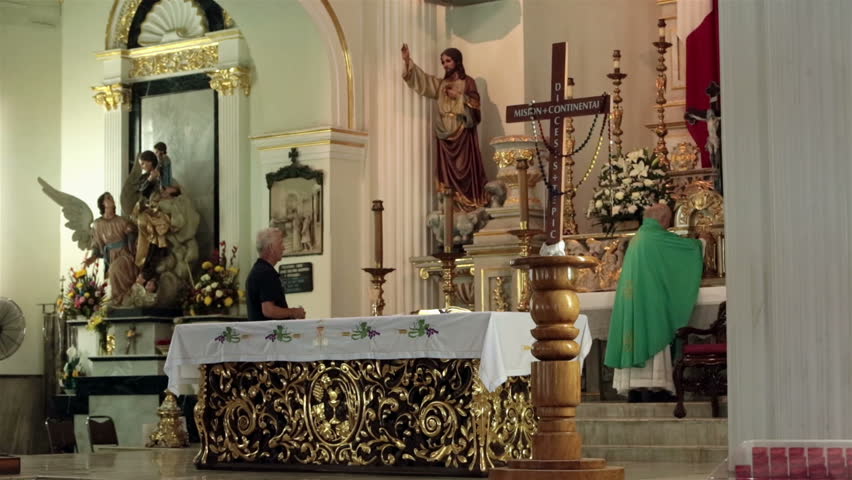 PUERTO VALLARTA, MEXICO - CIRCA NOV 2012: Priest performs the sacrament in Our Lady of Guadalupe church circa November 2012 in Puerto Vallarta, Mexico.