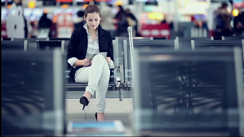 Pretty young female passenger at the airport (shallow DOF; color toned image)