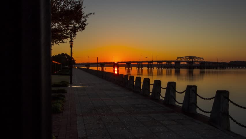 Timelapse of Sunrise at dawn, on a pier overlooking intracoastal waterway.
