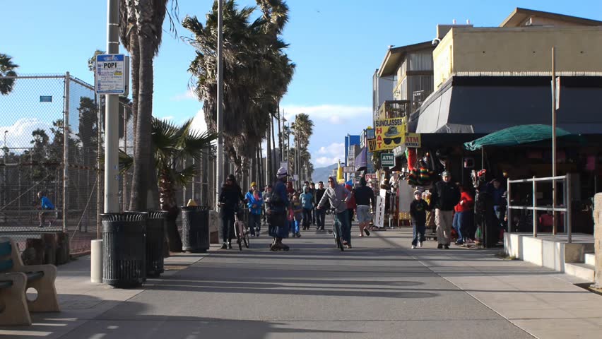 VENICE BEACH, CALIFORNIA - CIRCA 2011:  Tourists and locals walk on the boardwalk at Venice Beach, CA .